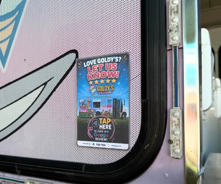 A custom-branded Tap-Tap review sign on the Goldy's Ice Cream truck